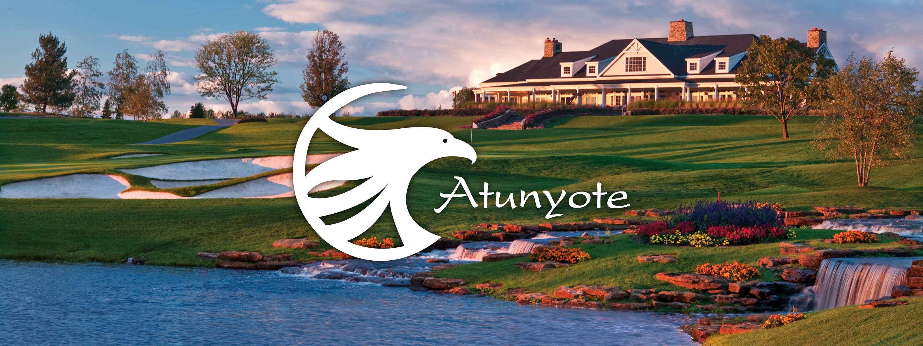 Panoramic view of Atunyote - an award winning  golf course with flowers and water stream and Clubhouse at Turning Stone Resor