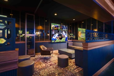 group of people seated watching sports games in a sports book