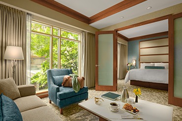 550 sq. ft. room with a separate living room and bedroom with a king bed.