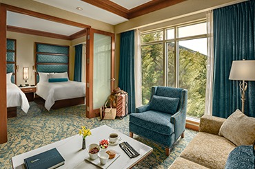 550 sq. ft. room with a separate living room and bedroom with two double beds.